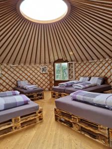 a room with four beds in a yurt at Casa Leon in Vrin