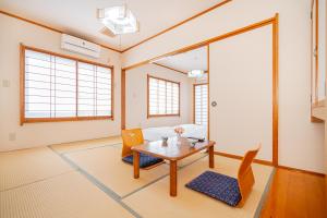 a living room with a table and chairs at 富士見の宿 in Gotemba