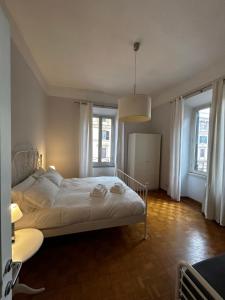 a bedroom with a bed and two windows at Vatican Attic in Rome