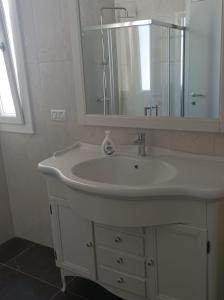 a bathroom with a white sink and a mirror at Dimora Erminia in Polignano a Mare +47 photos
