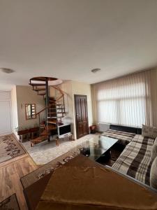 a living room with a couch and a table at Panorama Guest House in Smolyan