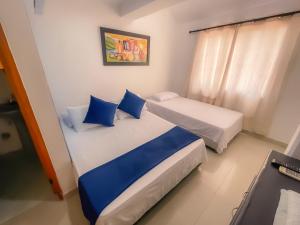 a room with two beds and a window at Sweet Caribbean Hotel in San Andrés