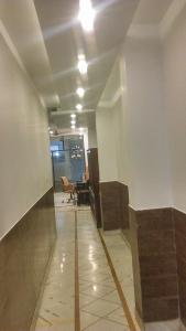 an empty hallway in an office building with a table at Aditya Inn Near New Delhi Railway Station Paharganj in New Delhi
