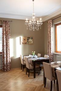 comedor con mesa, sillas y lámpara de araña en hideauts hotels Der Rosengarten, en Füssen
