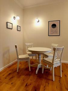 a dining room with a table and chairs at Old Town Comfort in Tarnów
