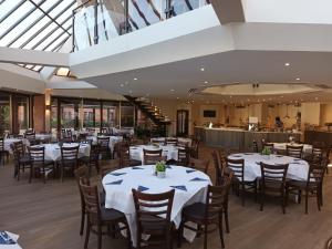 a dining room with white tables and chairs at CIM Business Centre in Maidenhead