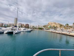 a boat in a harbor with boats in the water at Cesar Apartment in Alicante