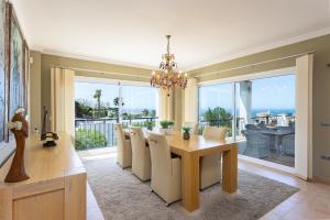 a dining room with a table and a view of the ocean at Villa Pugna - Private Pool, BBQ, Sauna in Benalmádena