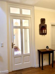 a door with a window and a table with candles at Ferienwohnung Schloss Heldritt in Bad Rodach