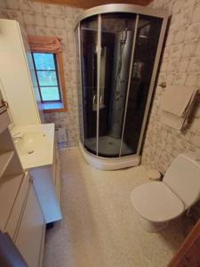 a bathroom with a toilet and a glass shower at Villa Naffen1 in Malmö