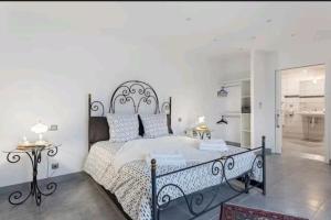 a bedroom with a large bed with a wrought iron headboard at Gite Mare e Montagne Drap 06 in Drap +19 photos
