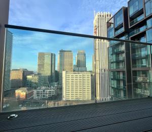 a view of a city skyline from a window at Luxury Modern 2 Bed Flat with Balcony + City View - Canary Wharf City Center in London