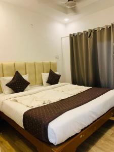 a large bed in a room with a curtain at 1 Bhk Apartment 200 mtr from beach in Calangute