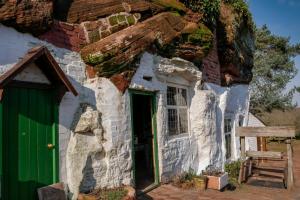 an old stone house with a green door at Cedar Cabin Holiday Let - Kinver in Stourbridge +8 photos