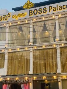 a large building with a sign that reads boss palace at Hotel Boss Palace in Mysore