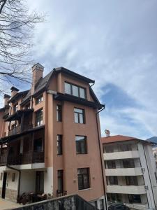 een groot bakstenen gebouw naast een appartementencomplex bij Panorama Guest House in Smolyan