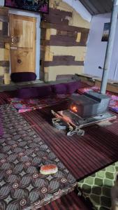 a fireplace in a room with a rug and a table at Devropa Heights in Malāna