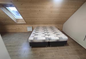 a bedroom with a bed in a attic at Železnohorské Apartmány u Sečskeho zámku in Seč