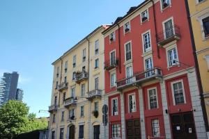 a row of colorful buildings on a street at Milano Cordusio in Milan