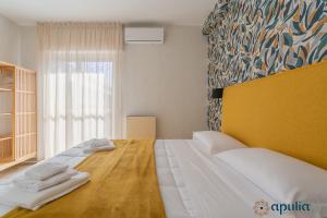 Postel nebo postele na pokoji v ubytování Einaudi Guesthouse by Apulia Accommodation