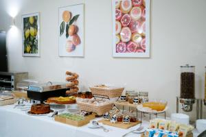 a table with various pastries and other food items at Hotel Premiere Pool & Resort in Marina di Varcaturo
