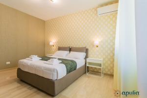 Postel nebo postele na pokoji v ubytování Einaudi Guesthouse by Apulia Accommodation