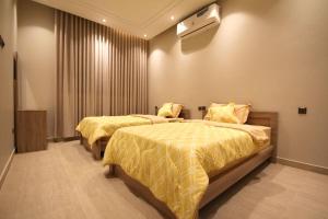 a bedroom with two beds and a window at شقة ارضية واسعة Spacious Ground Floor Apartment in Riyadh