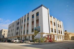 a large white building with cars parked in front of it at شقة ارضية واسعة Spacious Ground Floor Apartment in Riyadh