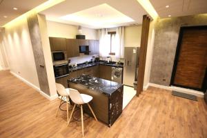 a kitchen with a counter and chairs in a room at شقة ارضية واسعة Spacious Ground Floor Apartment in Riyadh