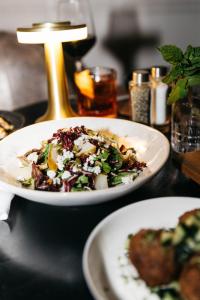 a table with two plates of food on a table at The Talbott Hotel in Chicago