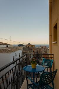 a table and chairs on a balcony with a view at Affittacamere le scale in Castellammare del Golfo