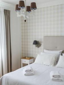 a bedroom with a white bed with two towels on it at Filigran II-Stylish Apartment with Free Parking in Ioannina