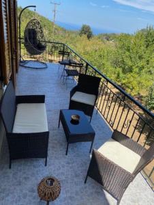 a balcony with chairs and a table on a balcony at Mike's Place in Raches