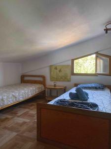 a bedroom with two beds and a window at Mike's Place in Raches +11 photos