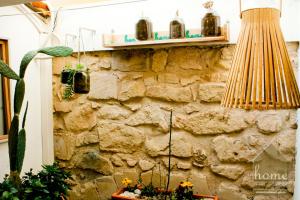 a room with a stone wall and a lamp at Casa vacanza home Ragusa in Ragusa