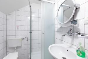 a bathroom with a shower and a sink and a mirror at Willa Bryza in Niechorze