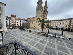 a large building with a clock tower in a city at La Redonda Catedral Ascensor by Apartamentos Logrono in Logroño