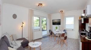 ein Wohnzimmer mit einer Couch und einem Tisch in der Unterkunft Bungalow "Wiesenblick" in Trassenheide