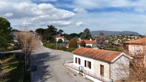 a small white house on a street with a road at N192 - Numana, nuova villetta con portico in Numana