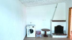a laundry room with a washing machine and a table at N192 - Numana, nuova villetta con portico in Numana