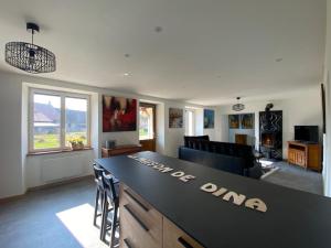 a kitchen and living room with a counter top at Gite bien-être hammam et jacuzzi ,sauna in La Grotte