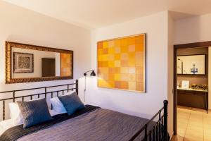 a bedroom with a bed and a mirror at Art House Ars Vivendi in Rīga