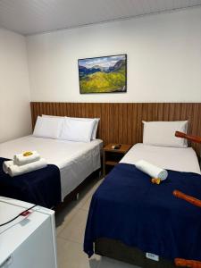 Łóżko lub łóżka w pokoju w obiekcie Vila Diamantina