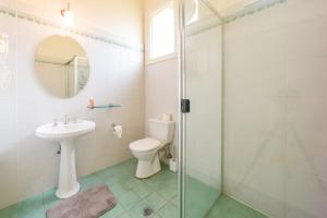 a bathroom with a toilet and a sink and a shower at East Sydney Hotel in Sydney