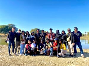 a group of people posing for a picture next to a lake at Hotel Murad Haveli Jaisalmer in Jaisalmer