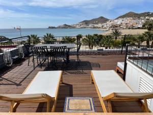 a patio with a table and chairs and the ocean at LF LEVEL San José in San José
