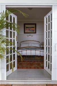 a bedroom with a bed through an open door at Fig Tree in Pretoria