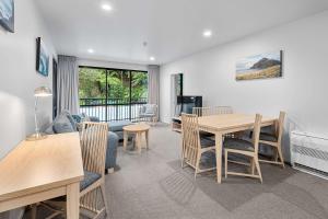 a living room with a table and a couch at Quality Hotel Oceans Tutukaka in Tutukaka