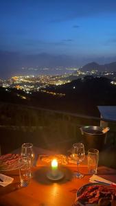a table with wine glasses and a candle on it at Appartamento Terrazza Vista Mare in Liguria, Genova, 5 Terre - gigiohomes in Cogorno