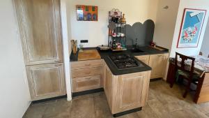 a kitchen with a stove and a counter top at Appartamento Terrazza Vista Mare in Liguria, Genova, 5 Terre - gigiohomes in Cogorno +19 photos